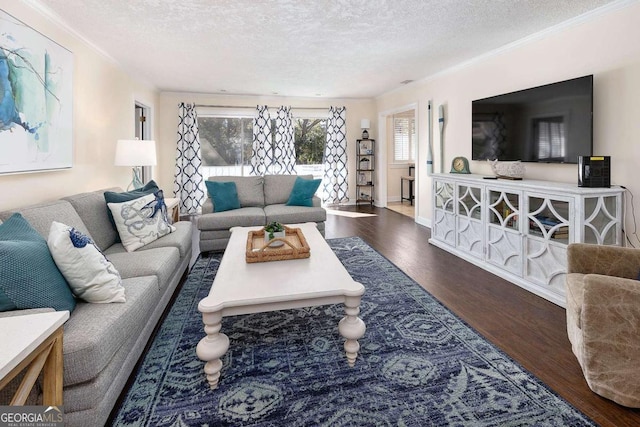 living room with dark hardwood / wood-style flooring, a textured ceiling, and ornamental molding