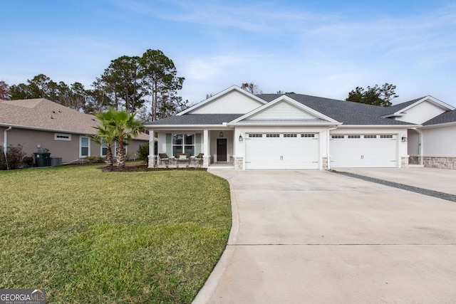 view of front of home with covered porch, a garage, and a front lawn