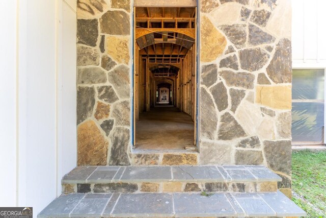 property entrance with stone siding