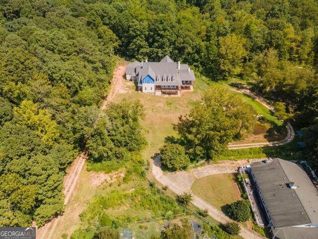 birds eye view of property with a wooded view