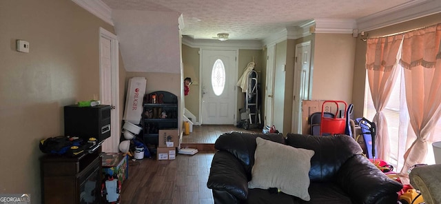 living room with hardwood / wood-style floors, crown molding, and a textured ceiling