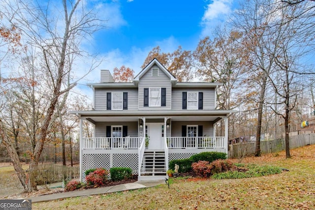 view of property with covered porch and a front yard