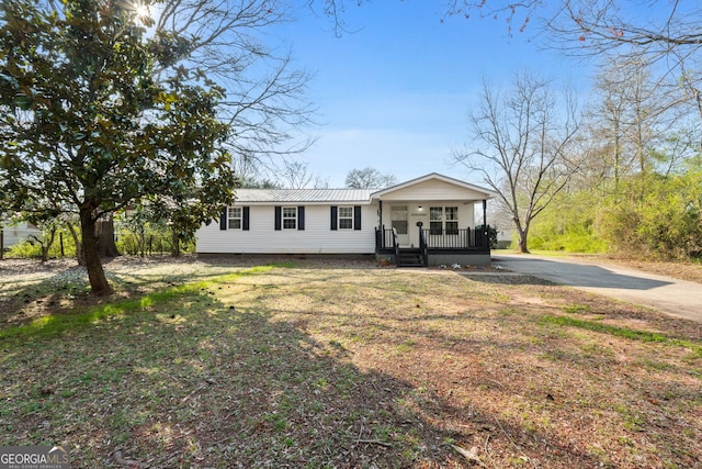 view of front of home featuring a porch and metal roof