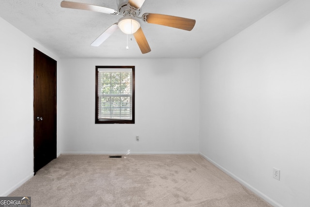 unfurnished bedroom featuring visible vents, ceiling fan, baseboards, and carpet