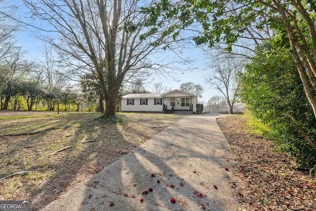 ranch-style home featuring concrete driveway