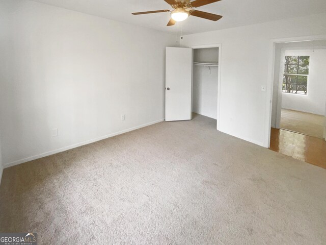 unfurnished bedroom featuring carpet, a closet, and ceiling fan