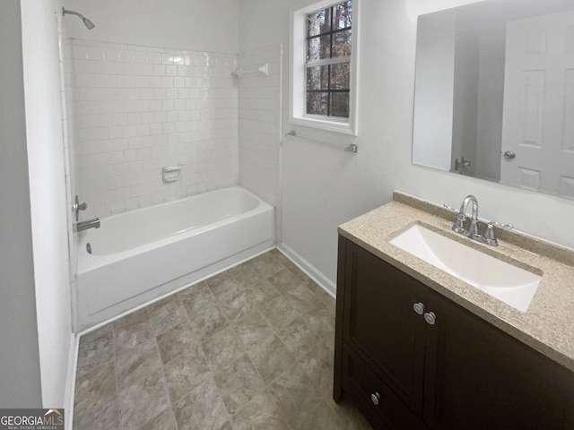 bathroom with vanity and tiled shower / bath