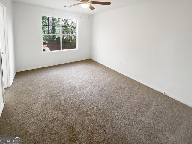 empty room with carpet floors and ceiling fan