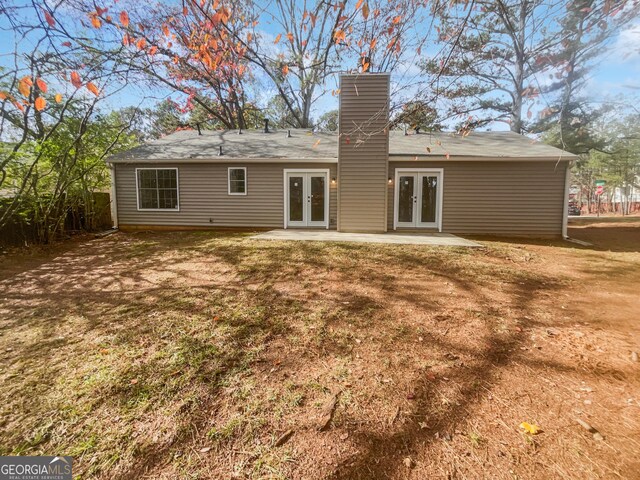 rear view of house with french doors and a patio