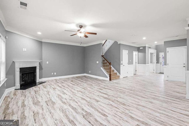 unfurnished living room with light hardwood / wood-style flooring, ceiling fan, and ornamental molding