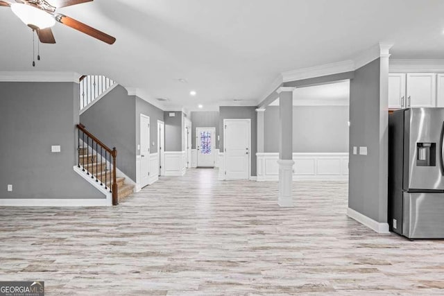 unfurnished living room with crown molding, ceiling fan, and light wood-type flooring