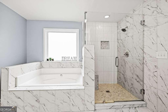 bathroom featuring shower with separate bathtub