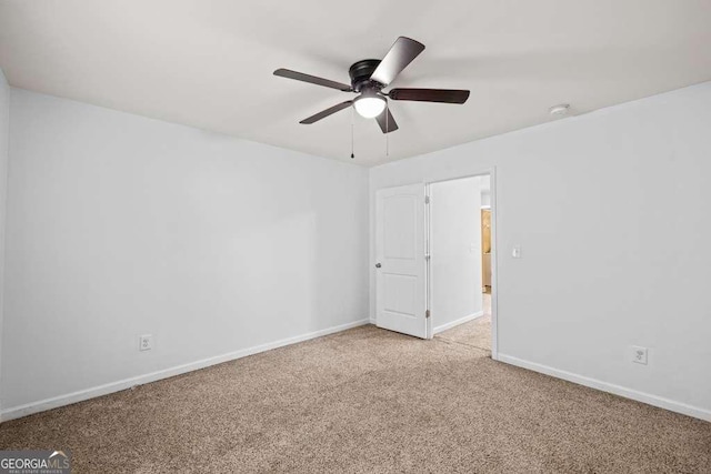 spare room featuring ceiling fan and light colored carpet