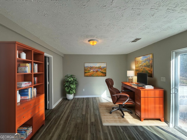 office featuring dark wood-type flooring, a textured ceiling, and plenty of natural light