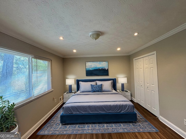 bedroom with dark hardwood / wood-style flooring, a closet, ornamental molding, and a textured ceiling