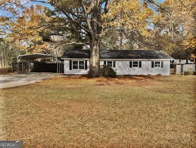 ranch-style house featuring a front yard and a carport