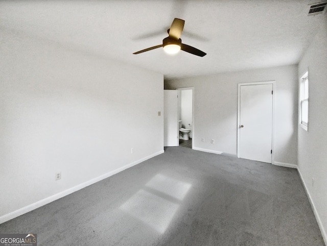 unfurnished bedroom featuring ceiling fan, carpet floors, and ensuite bath