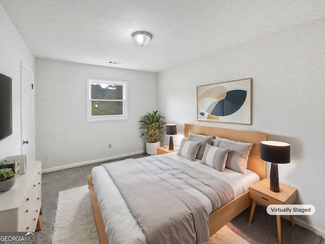 bedroom with carpet and a textured ceiling