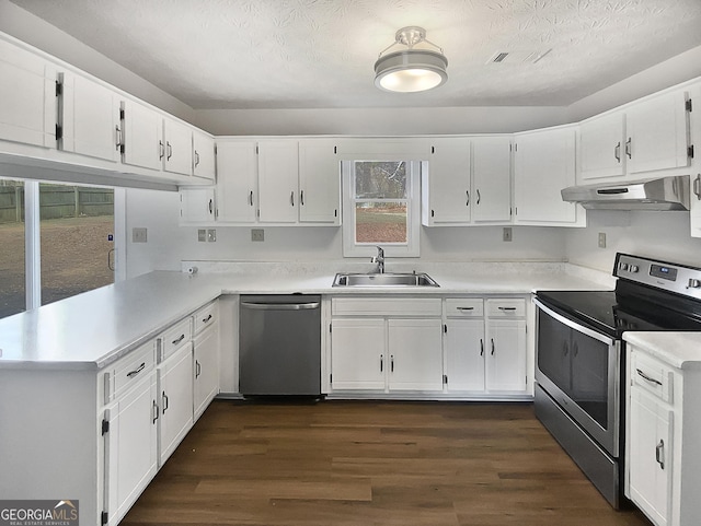 kitchen with white cabinets, sink, appliances with stainless steel finishes, and dark wood-type flooring