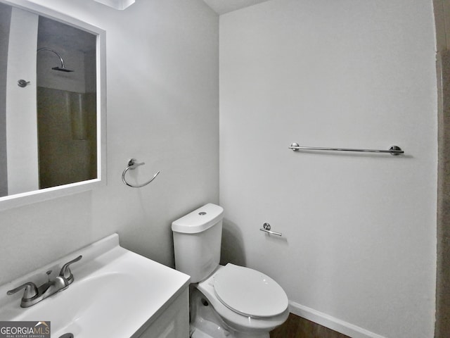 bathroom with hardwood / wood-style floors, vanity, and toilet