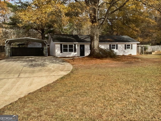 ranch-style home featuring a front yard and a carport