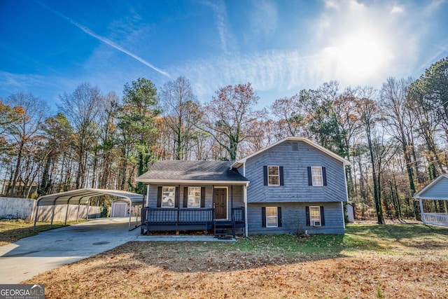 split level home featuring a carport, covered porch, and a front lawn