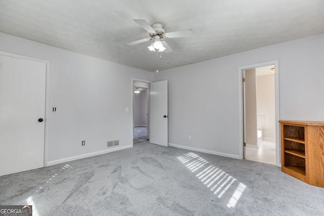 unfurnished bedroom featuring light carpet and ceiling fan