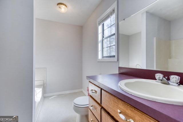 bathroom with vanity, toilet, and a washtub