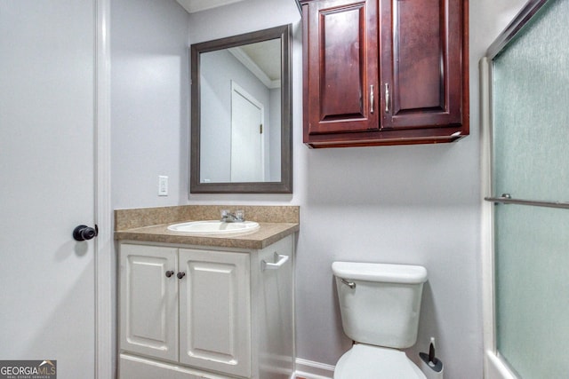 bathroom with crown molding, vanity, and toilet