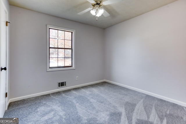 unfurnished room with ceiling fan and carpet