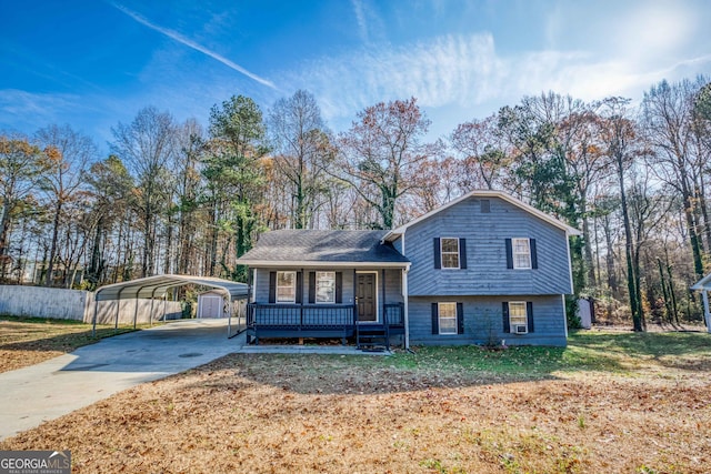 tri-level home featuring a front yard, a porch, and a carport