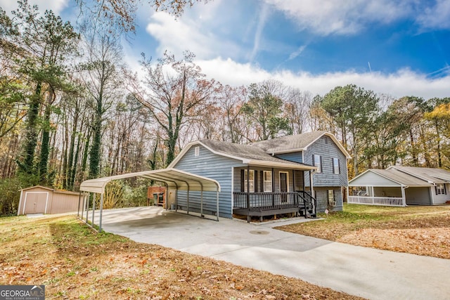 view of front of house featuring a front yard, a storage unit, a porch, and a carport