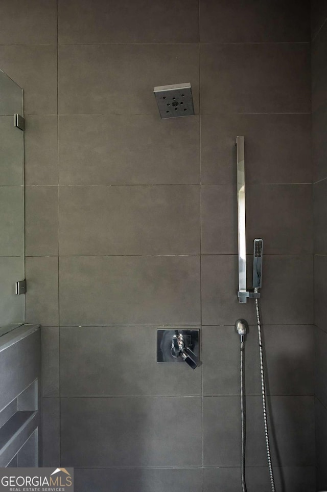 bathroom with tiled shower