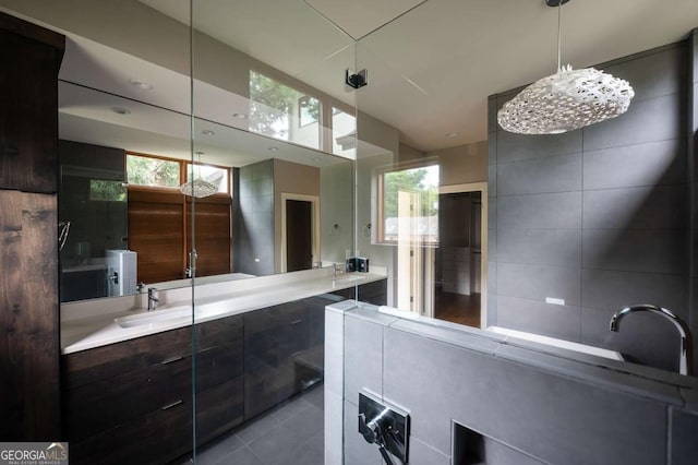 bathroom featuring sink, a healthy amount of sunlight, and tile patterned flooring