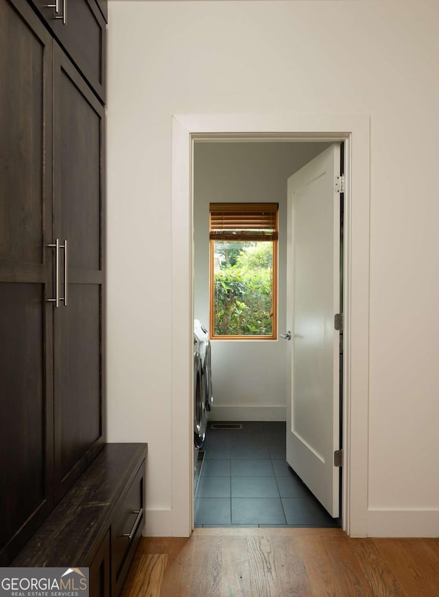 washroom with independent washer and dryer and dark wood-type flooring