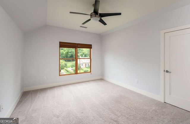 carpeted empty room with ceiling fan and lofted ceiling