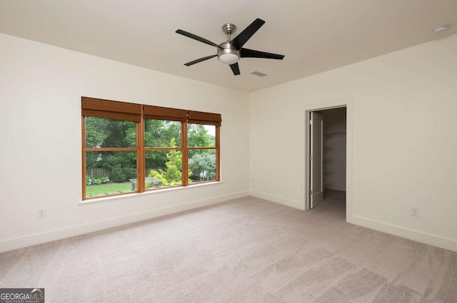 empty room featuring light carpet and ceiling fan