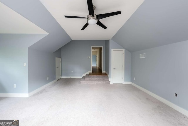 additional living space with ceiling fan, light colored carpet, and lofted ceiling