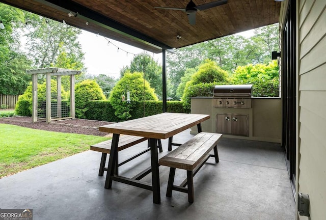 view of patio / terrace featuring a grill, ceiling fan, and exterior kitchen