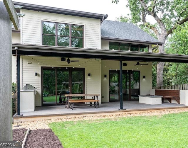 rear view of house with ceiling fan and a patio