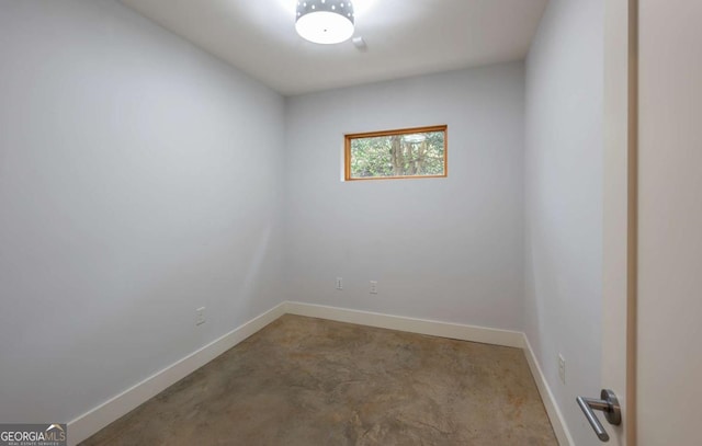 unfurnished room with concrete floors