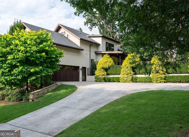 view of front of property featuring a garage and a front lawn