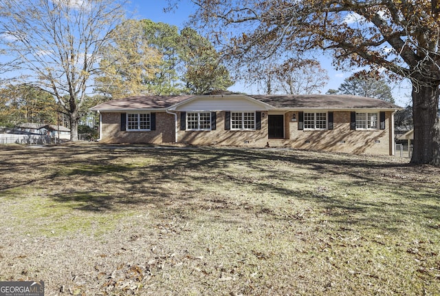 ranch-style home featuring a front yard