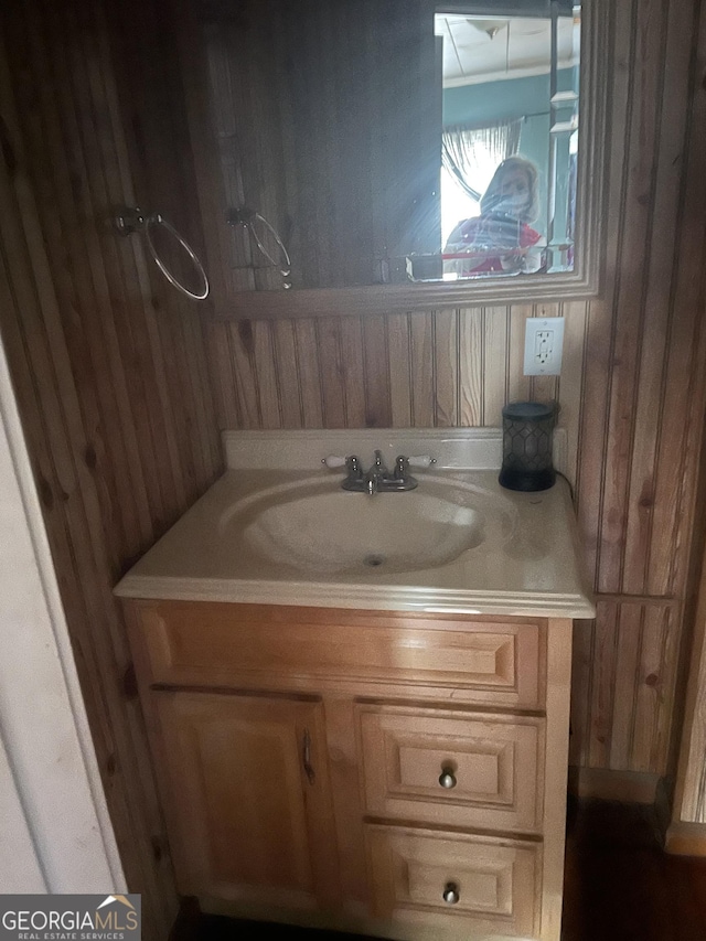 bathroom with wood walls and vanity