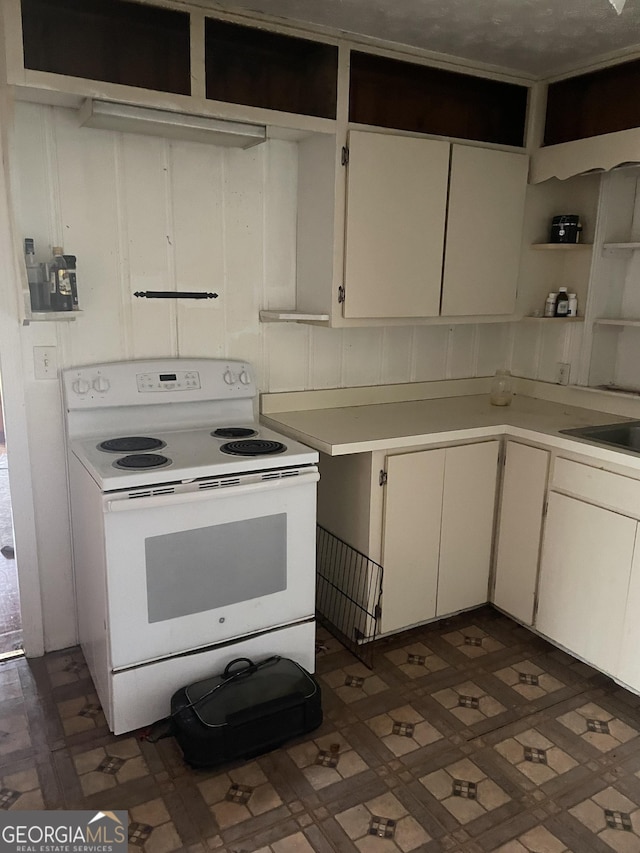 kitchen featuring sink, white cabinets, and white range with electric stovetop