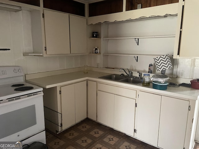 kitchen with sink, white electric stove, white cabinetry, and tasteful backsplash