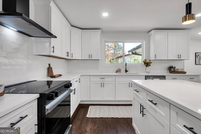 kitchen with electric range, white cabinets, wall chimney range hood, and sink