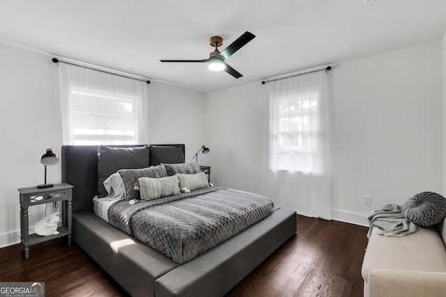 bedroom with multiple windows, ceiling fan, and dark hardwood / wood-style floors