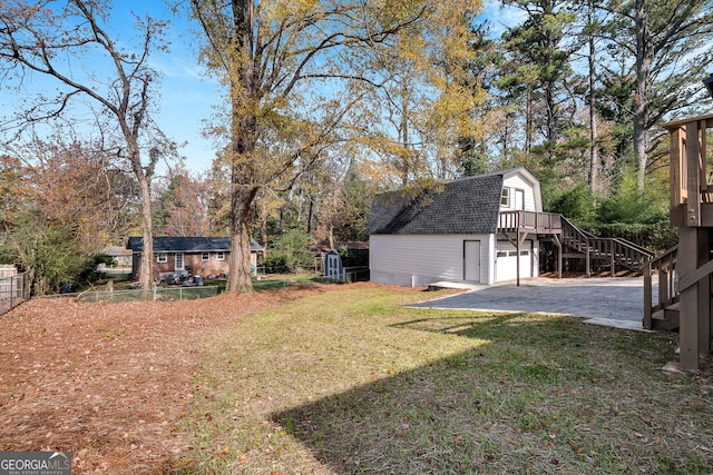 view of yard with a wooden deck and an outbuilding