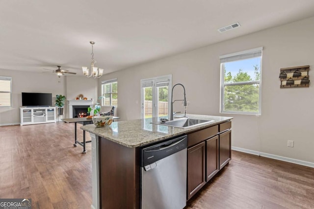 kitchen with dishwasher, decorative light fixtures, dark brown cabinets, and sink